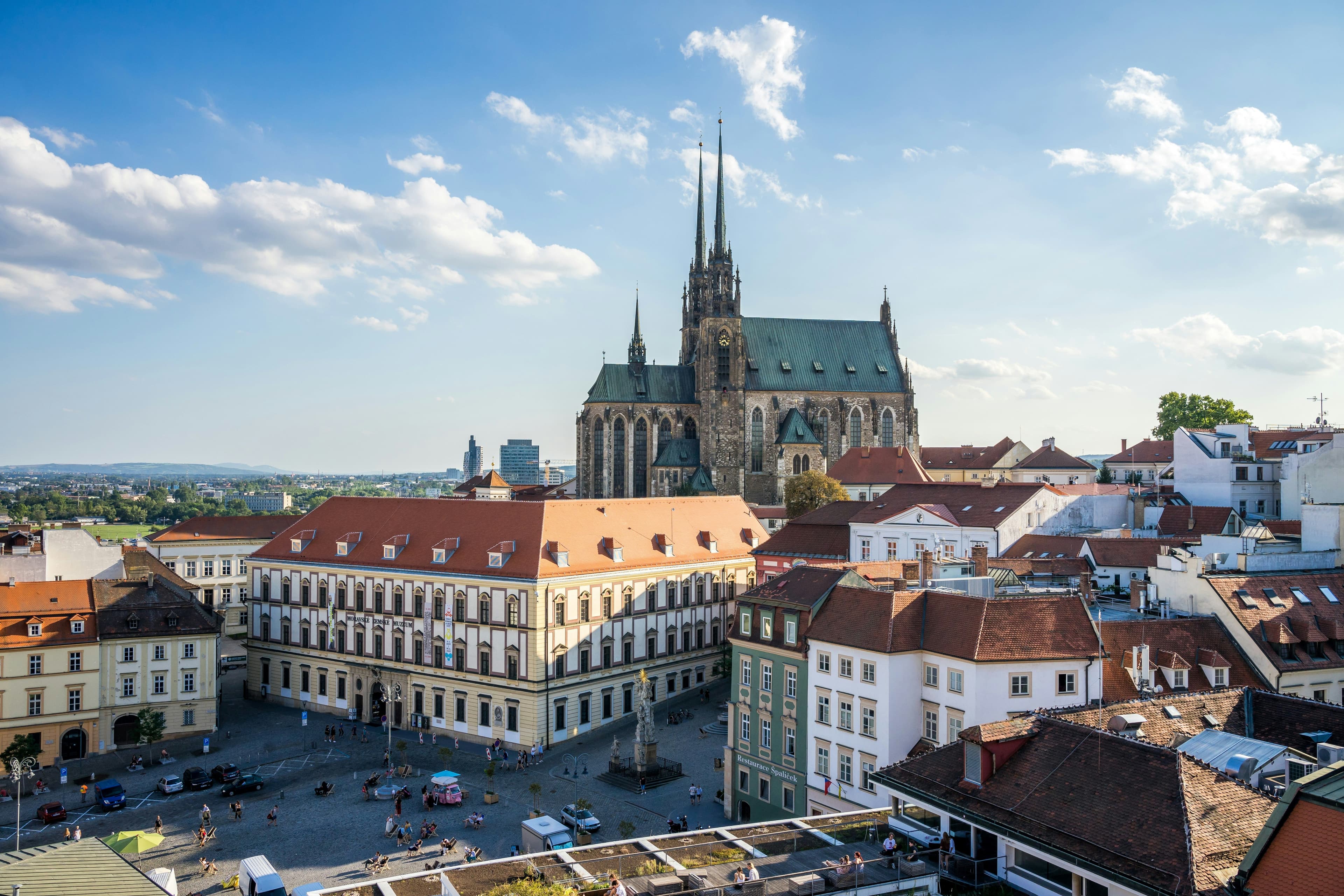 City of Brno from above with a castle in the background and residential buildings in the front