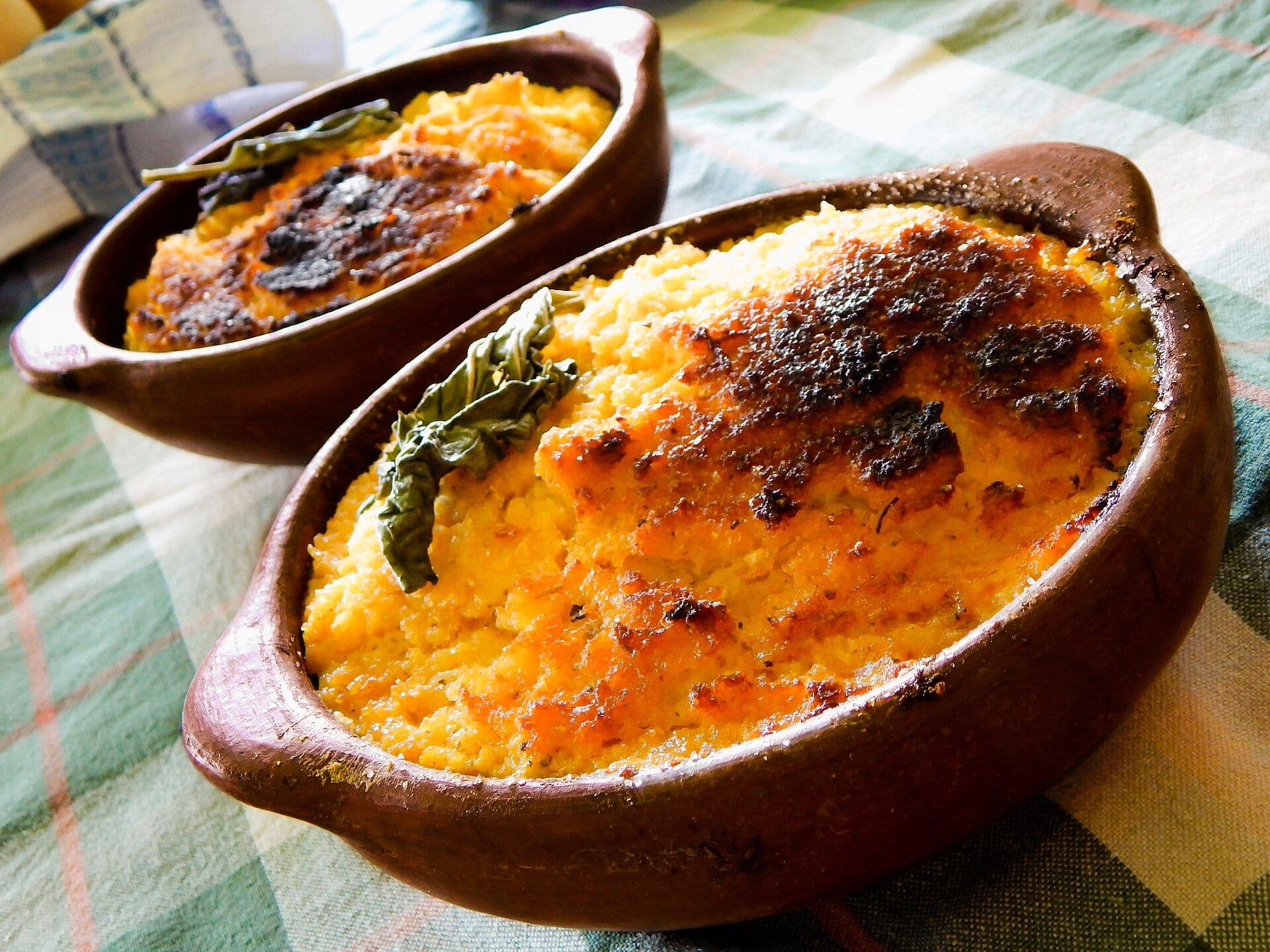 A round bowl of Pastel de choclo on a white plate.