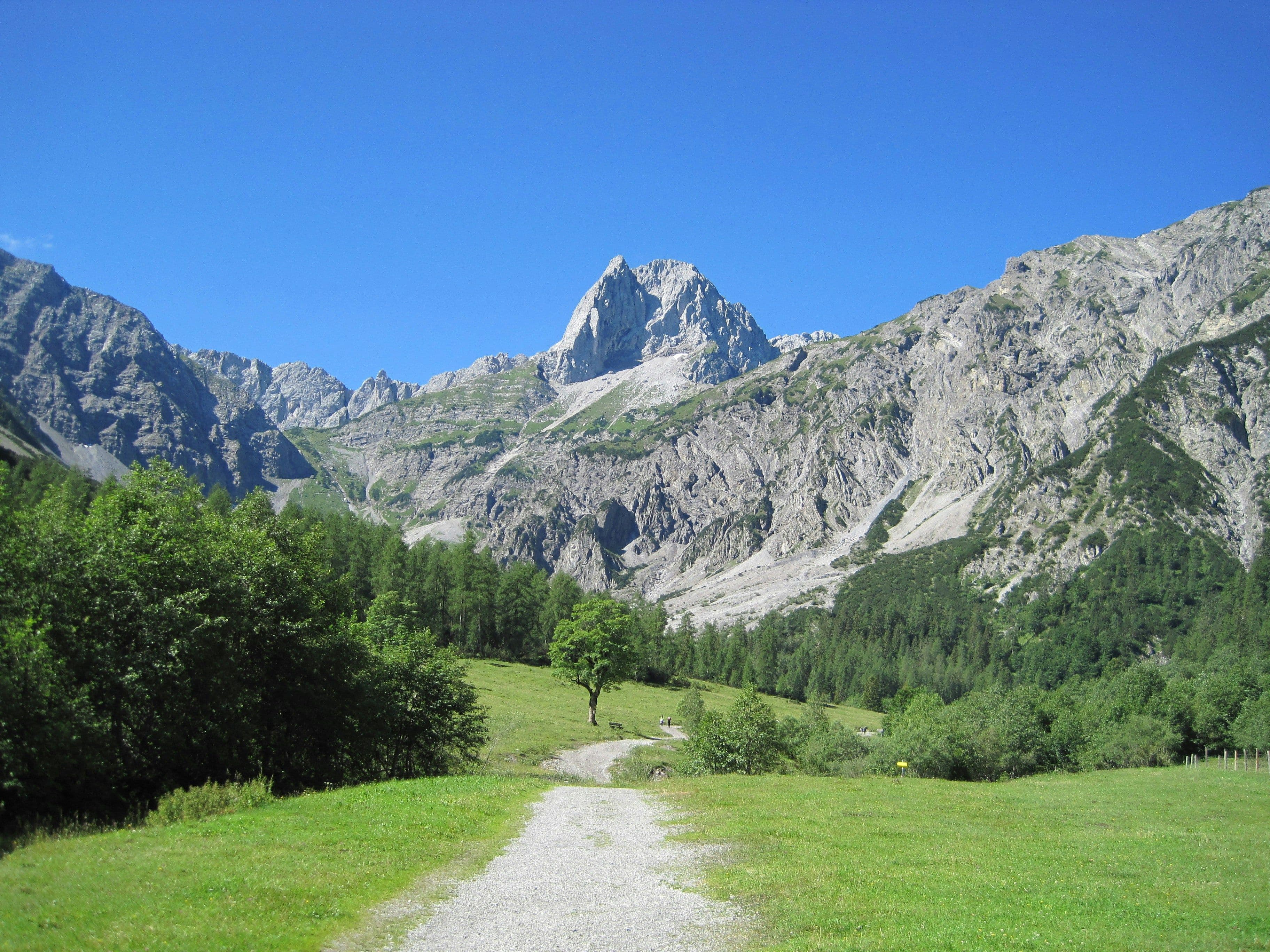 Rocky mountain landscape and a green grass area