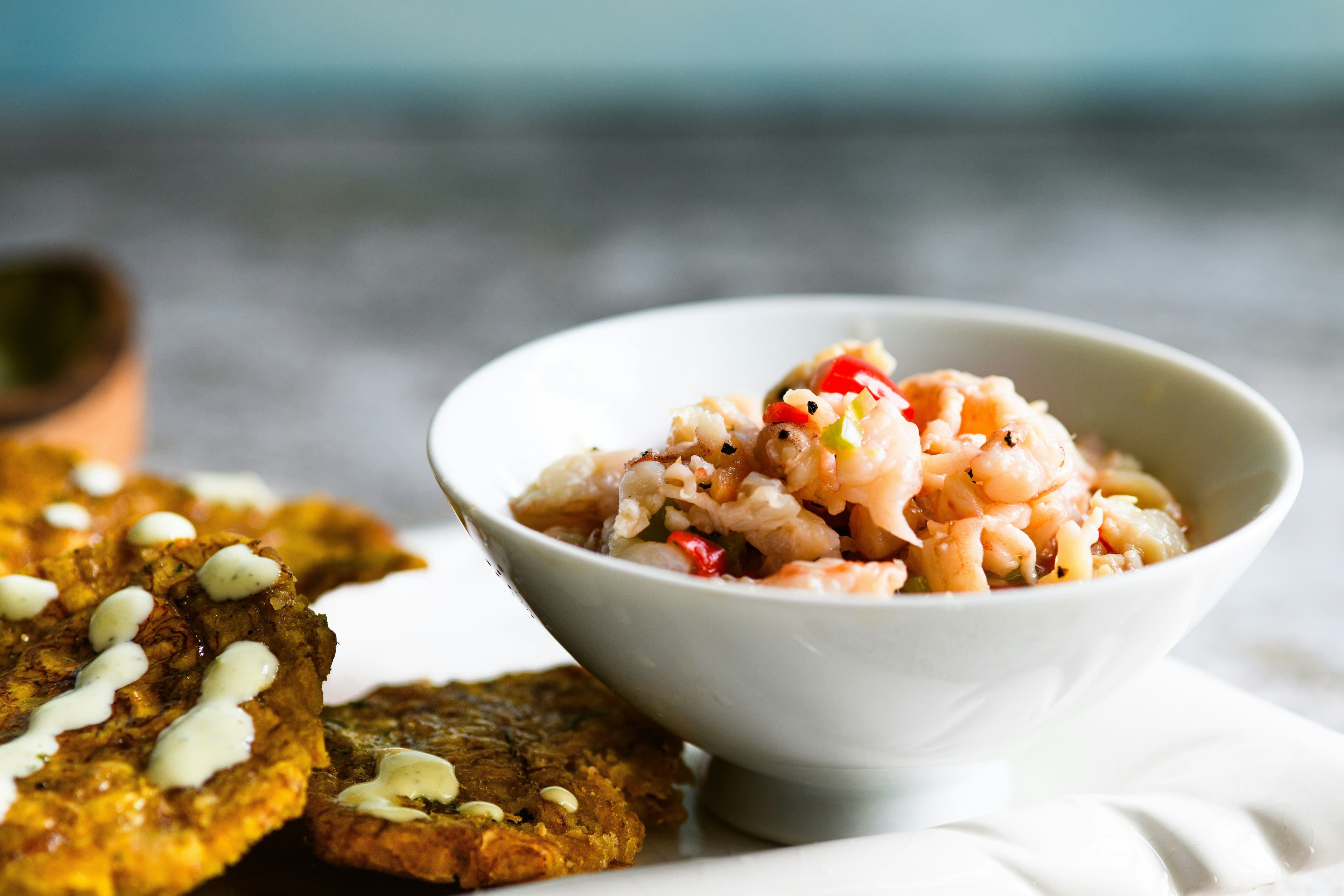 A white bowl of ceviche fish