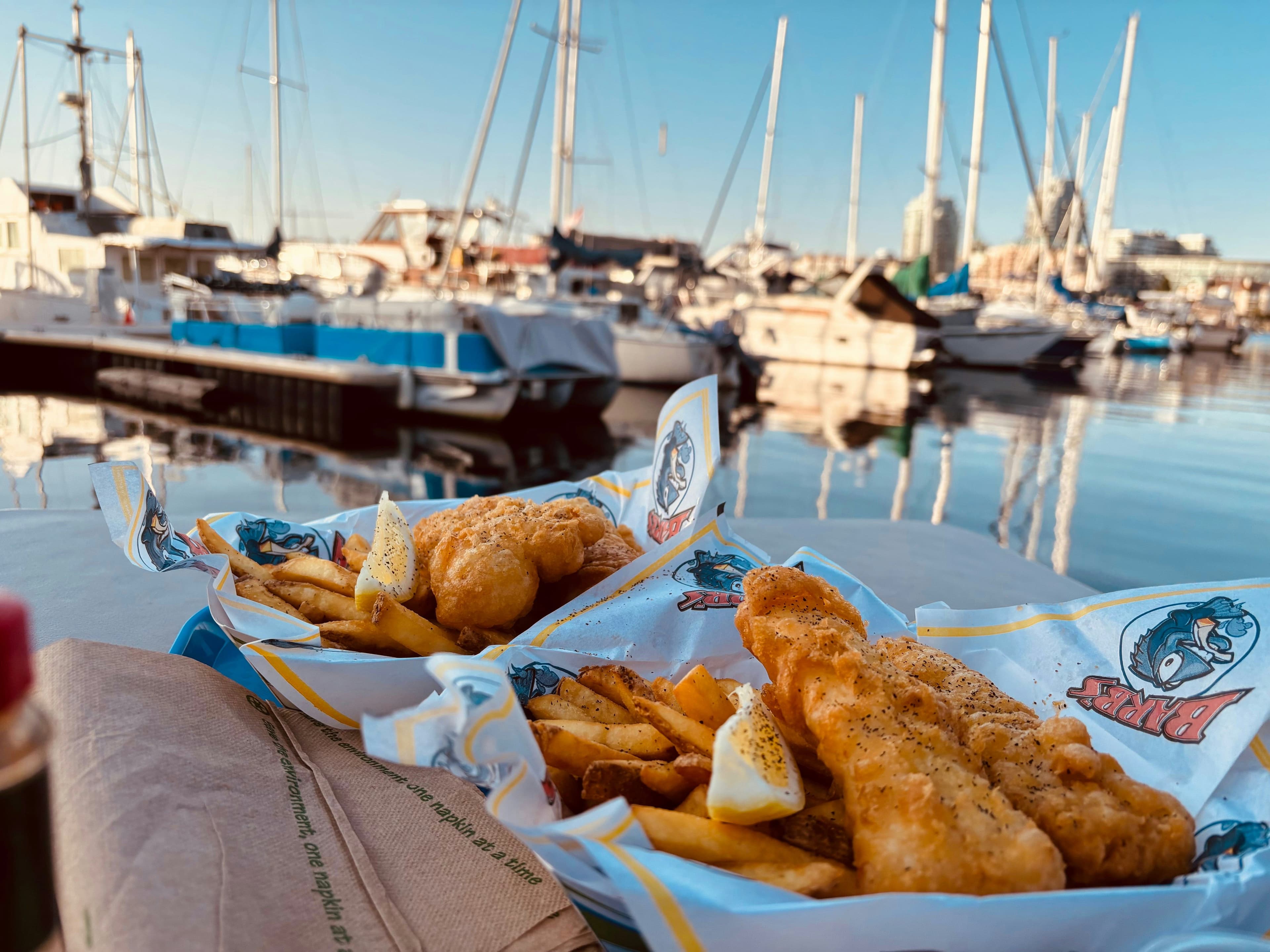 Fish and chips with a harbour in the background