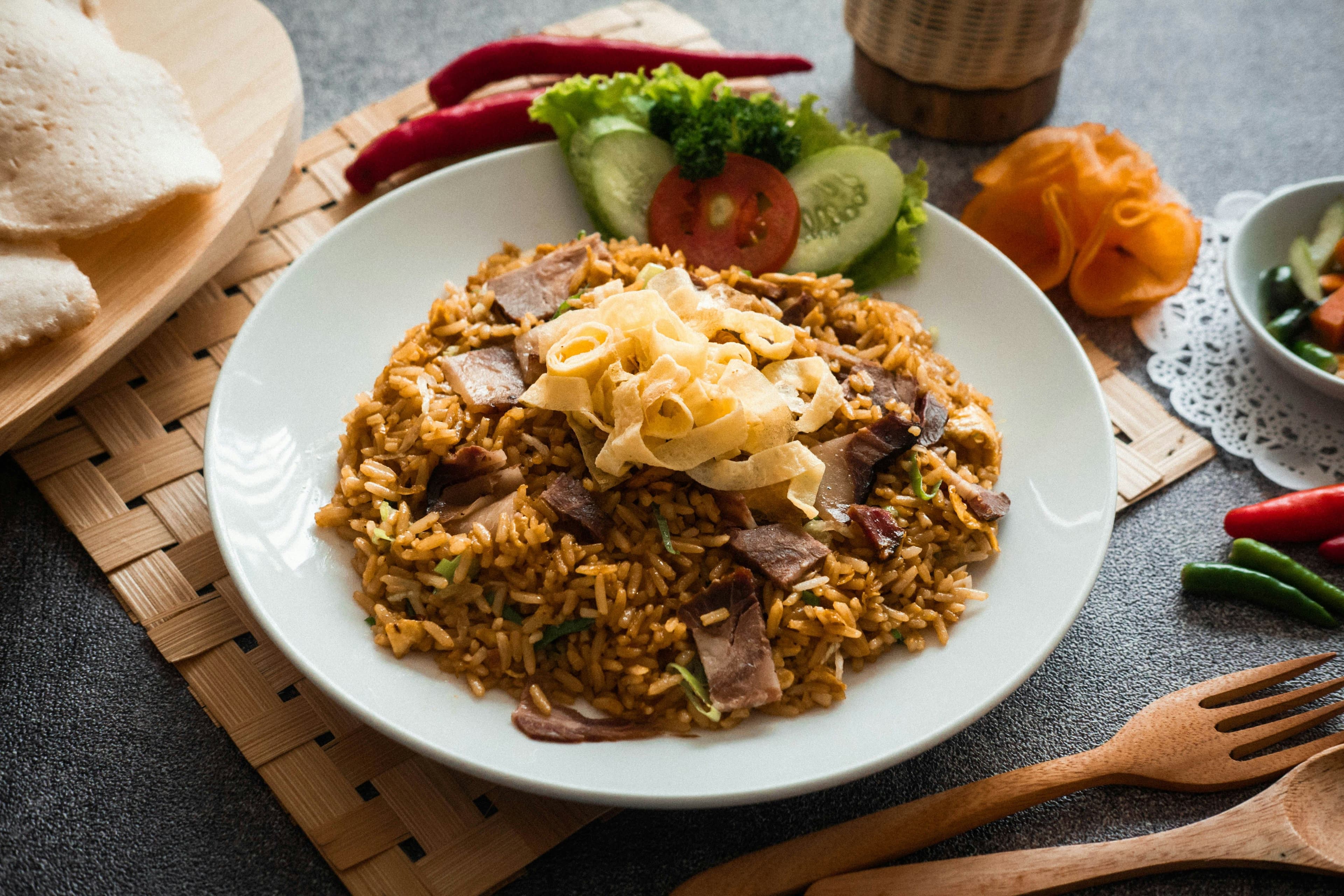 A picture of nasi goreng served on a white plate