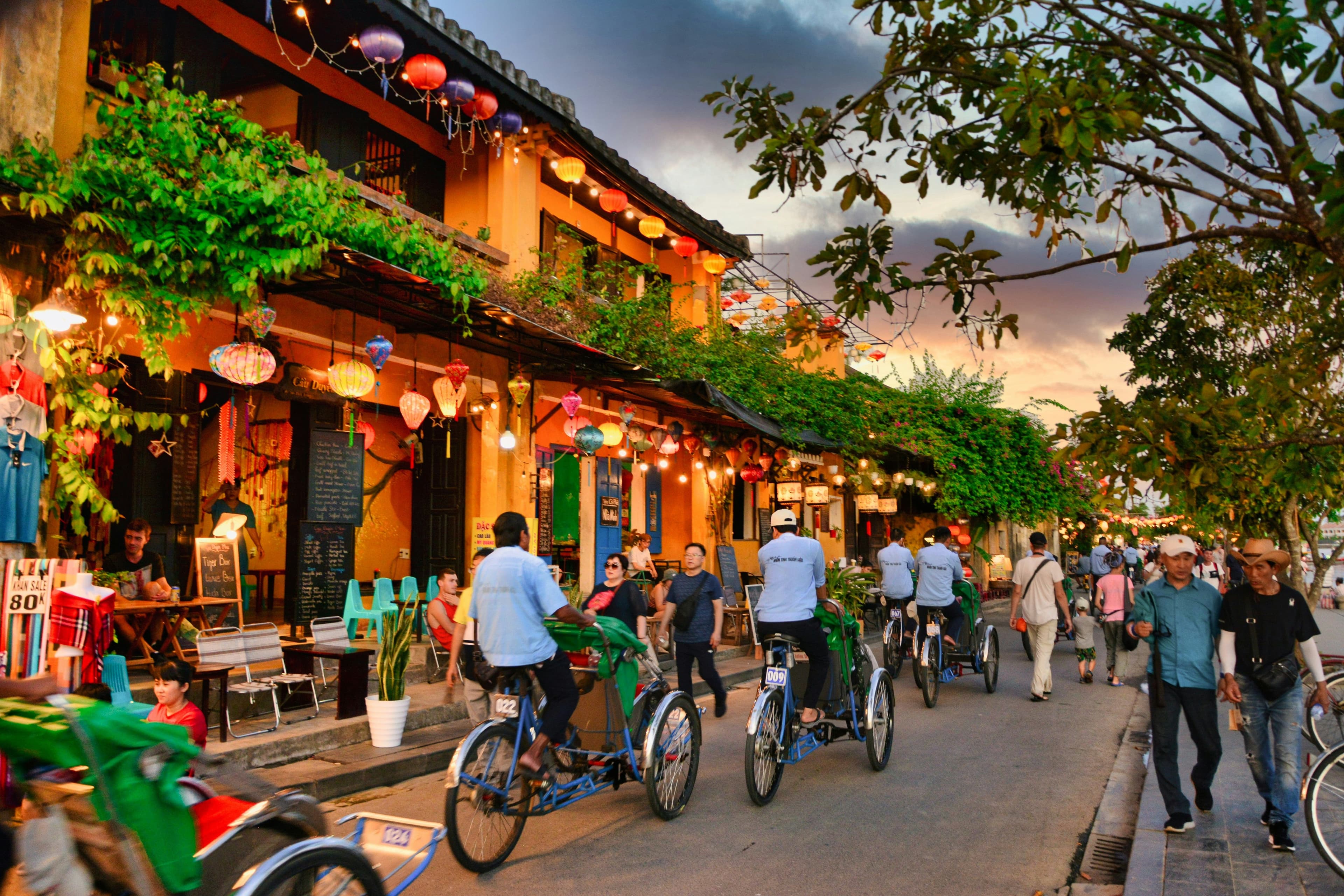 Bicycles and colorful lanterns in a street in hoi an during the evening