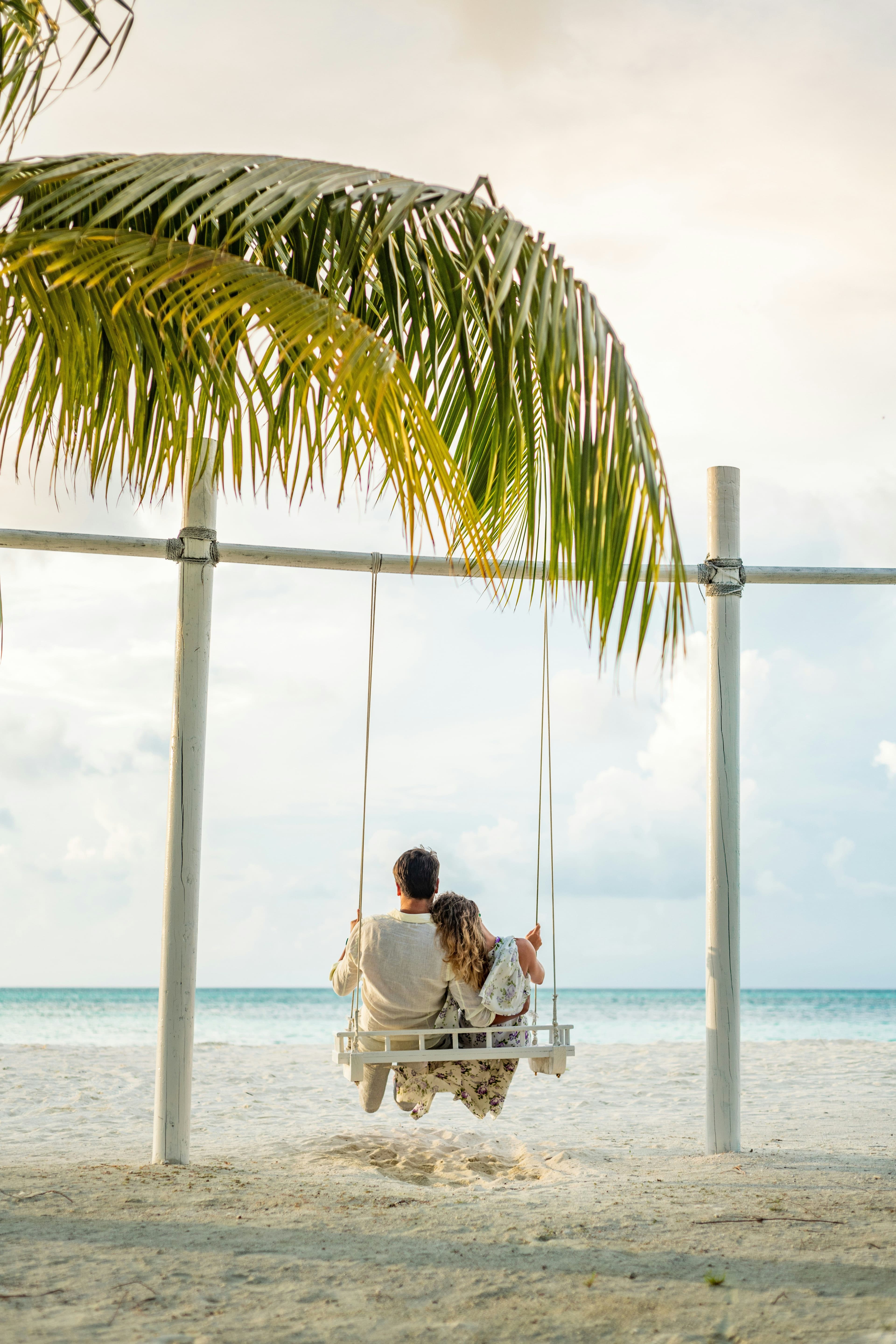 couple on beach swing