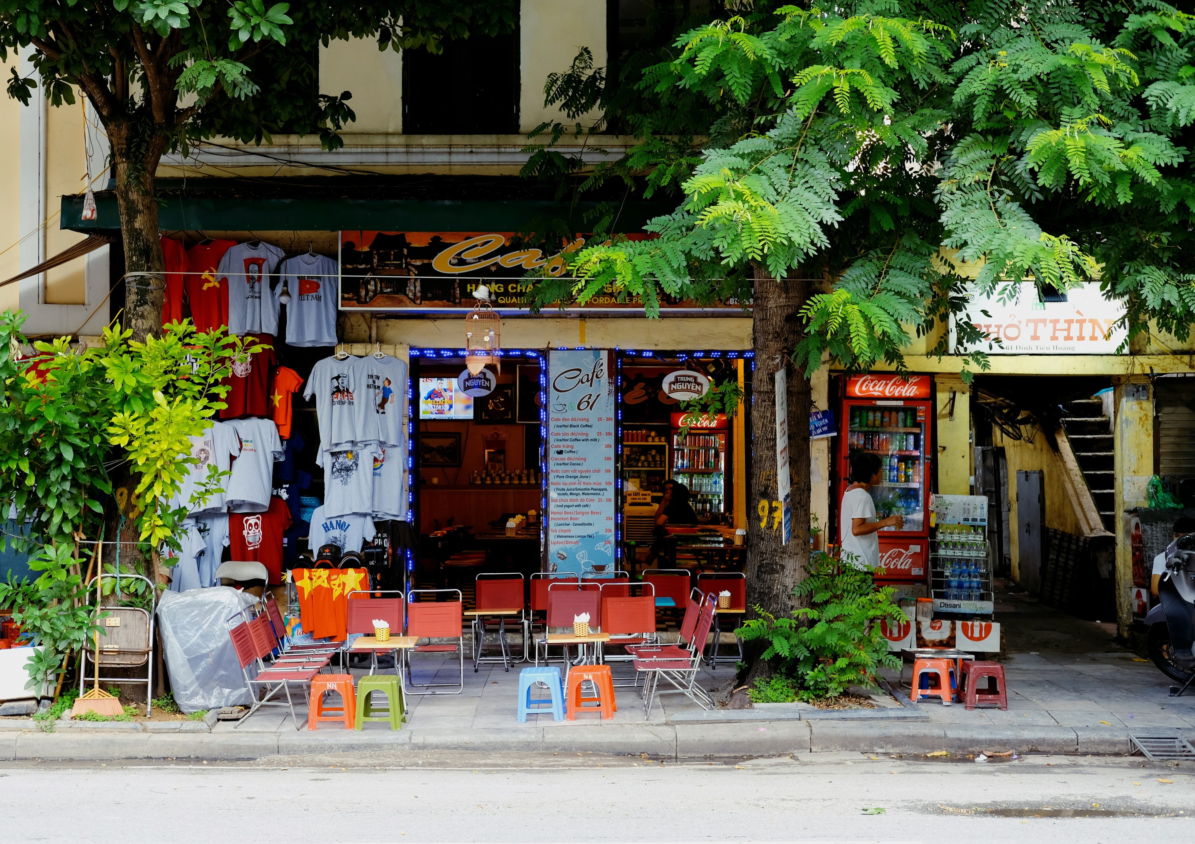 A front view of a local shop in hanoi vietnam with colorful chairs