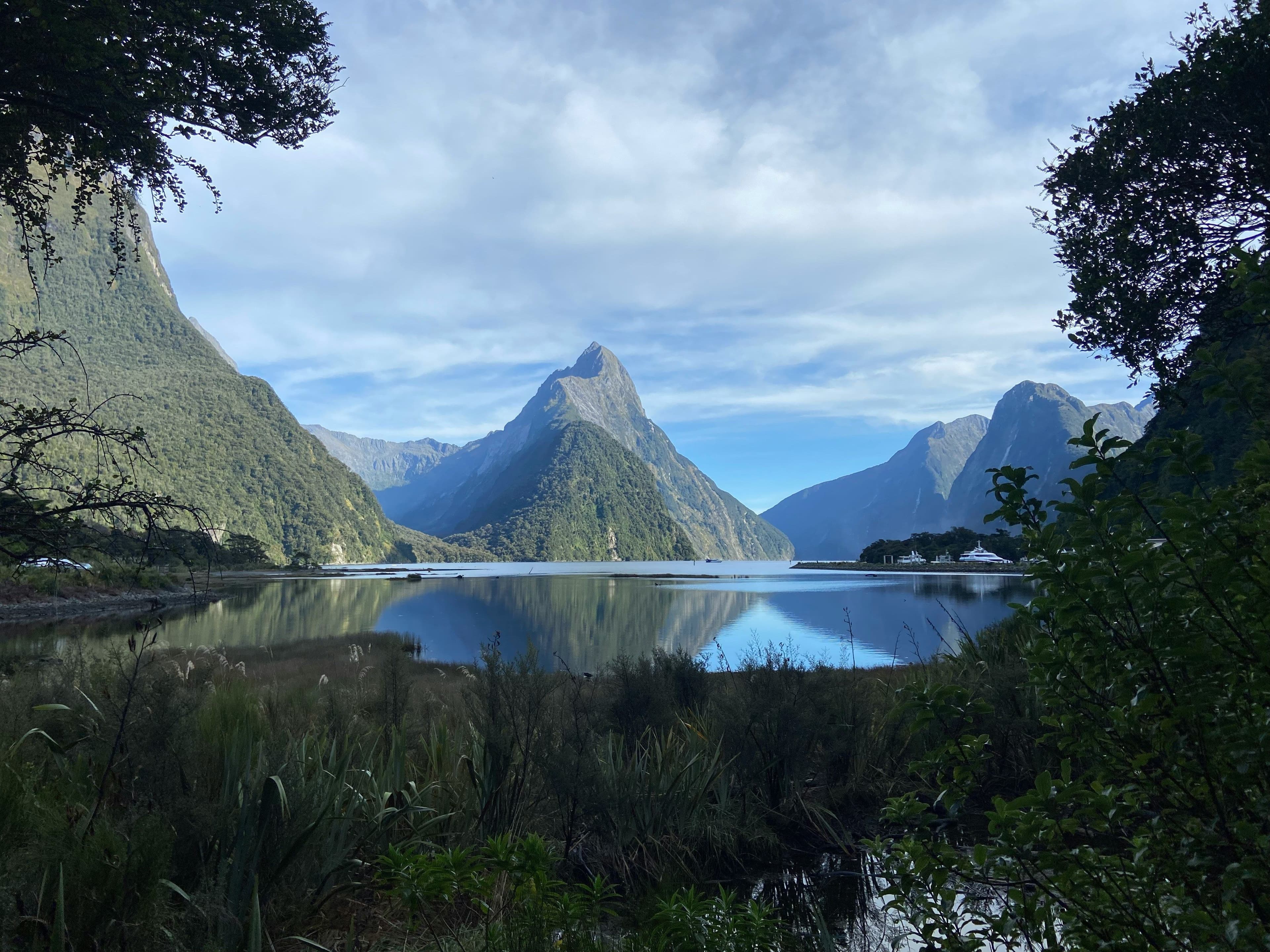 Milford Sound: a lake in new zealand surrounded by mountain peaks