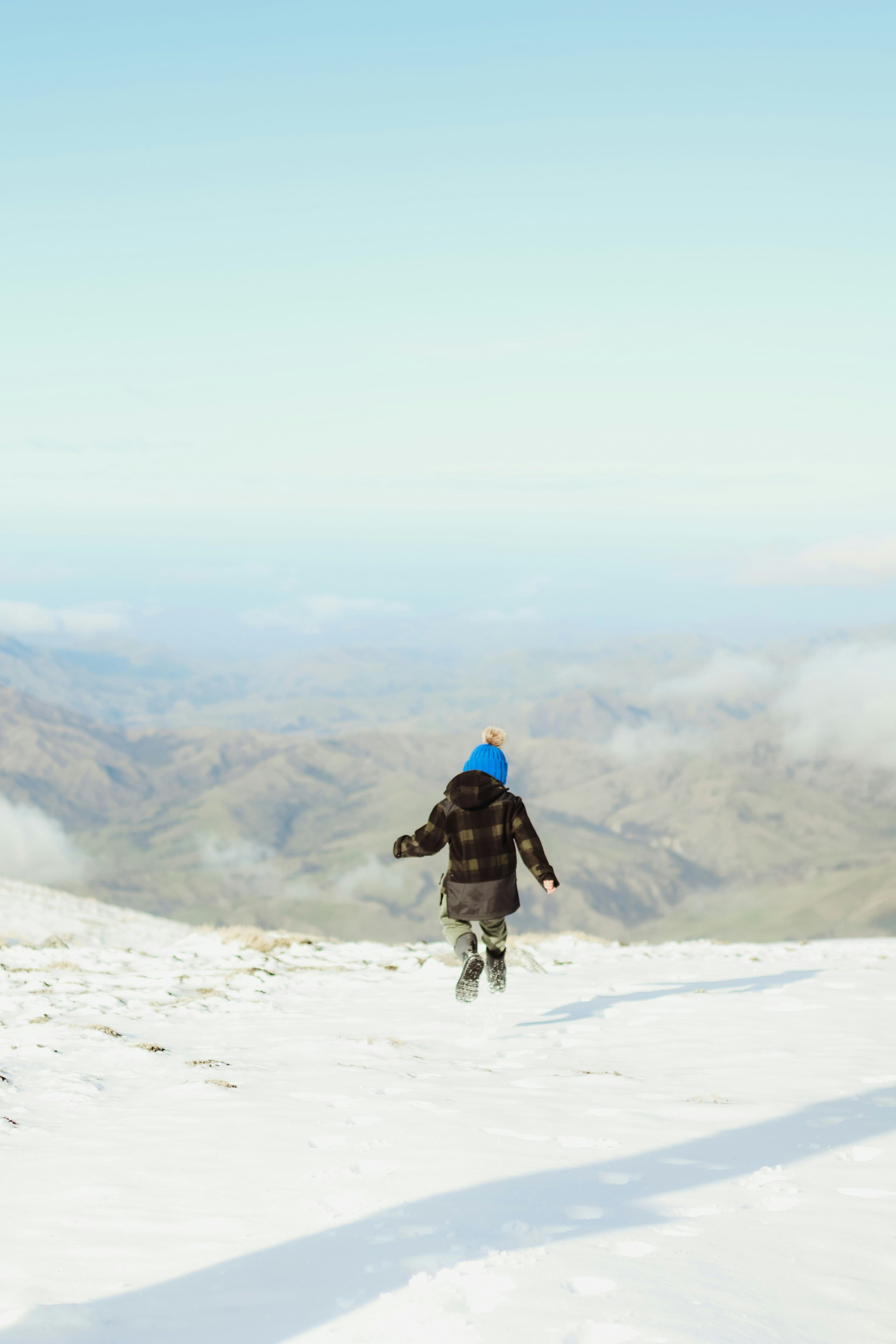 baby walking on snowy mountain