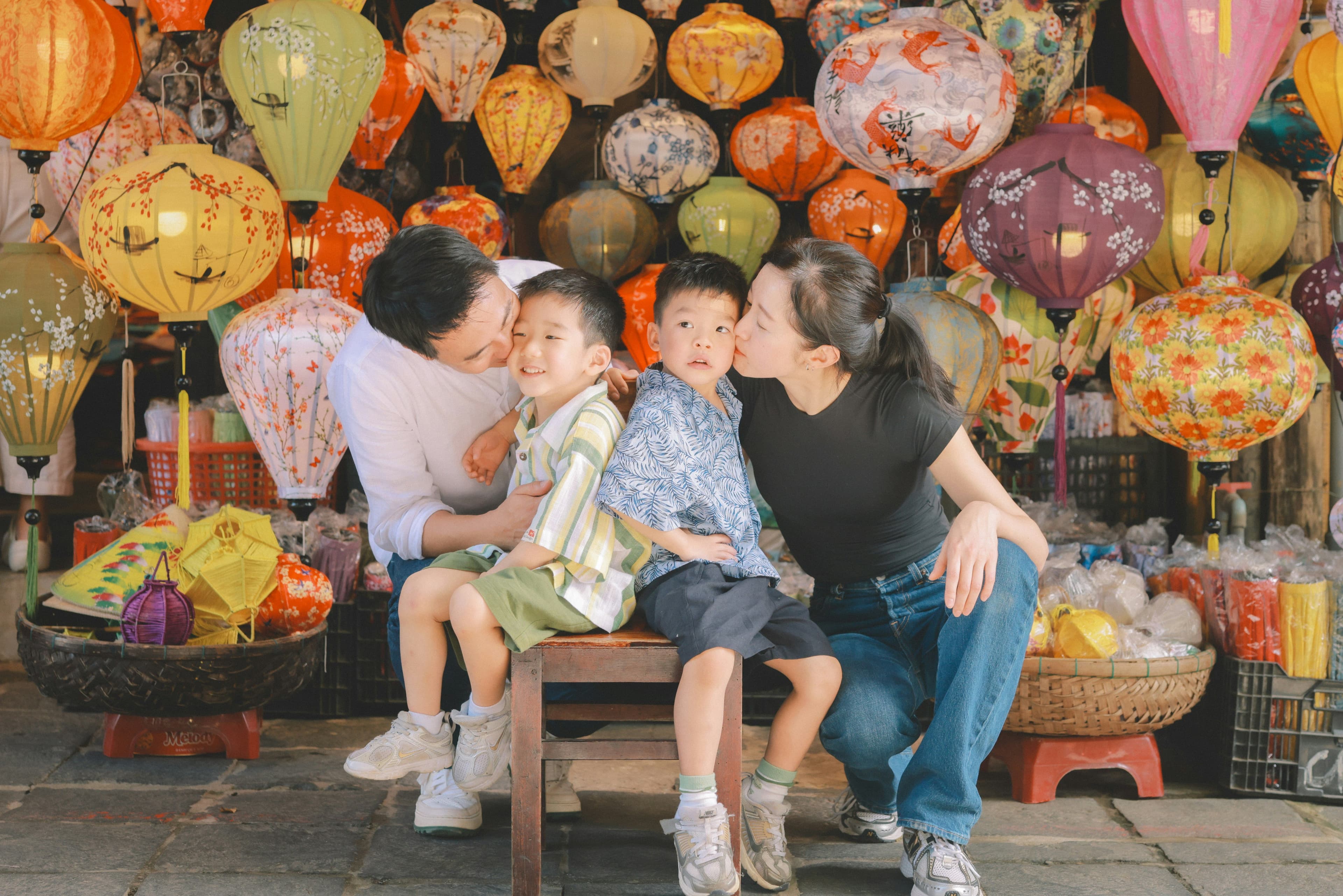 Happy family sitting in front of vietnamese lanterns