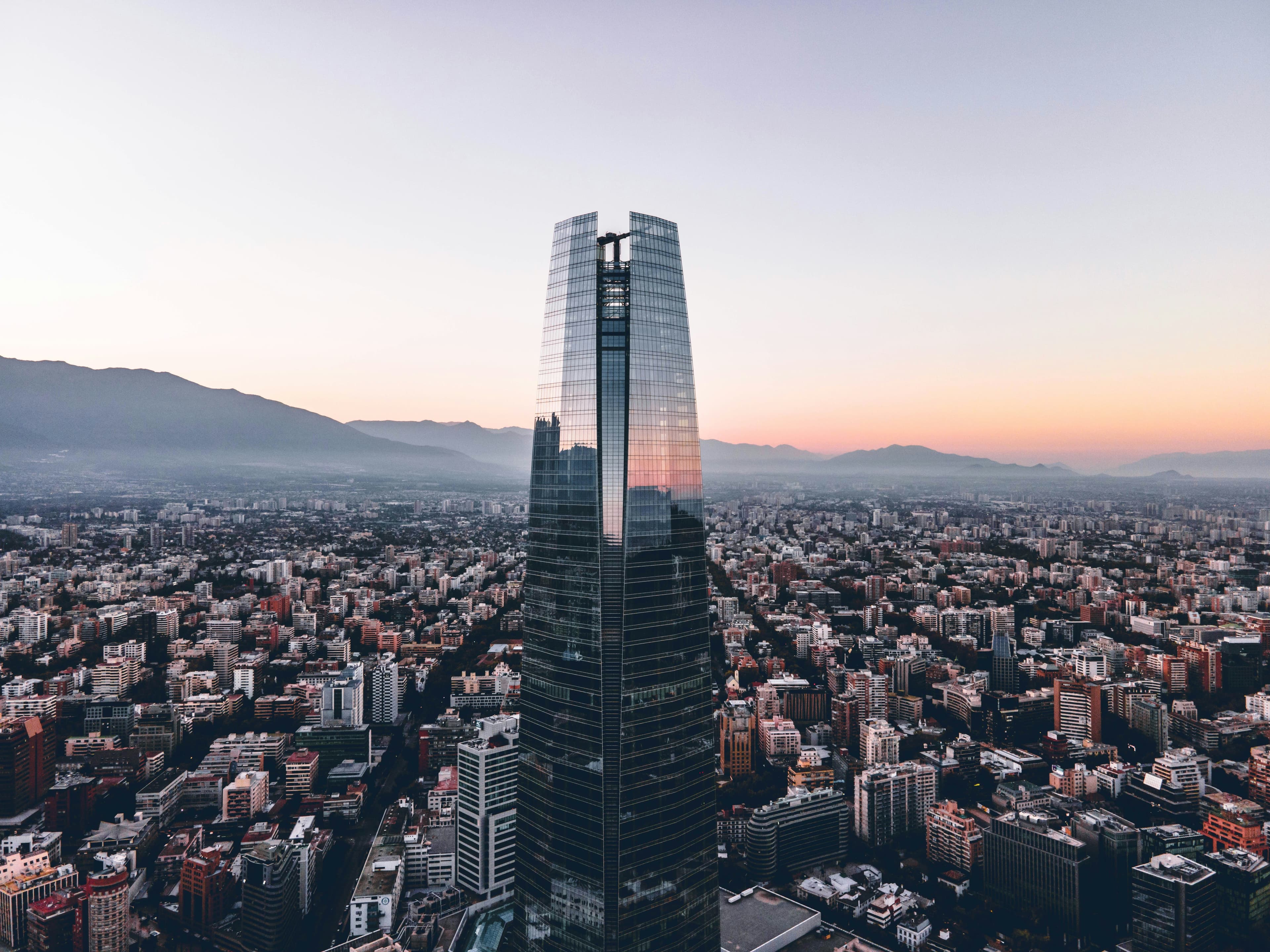 Skyscraper in Santiago during sunset with city below