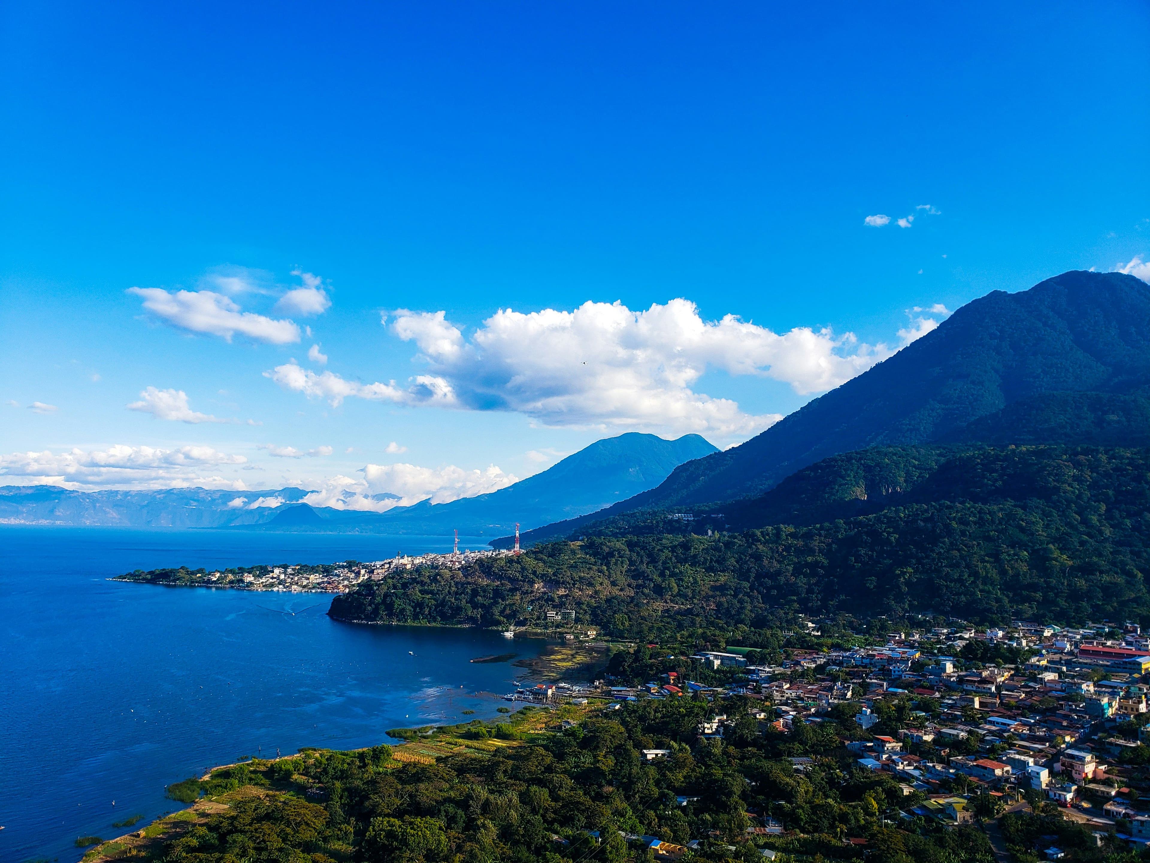 Mountain and ocean on a clear day with blue sky and a few clouds in Guatemala