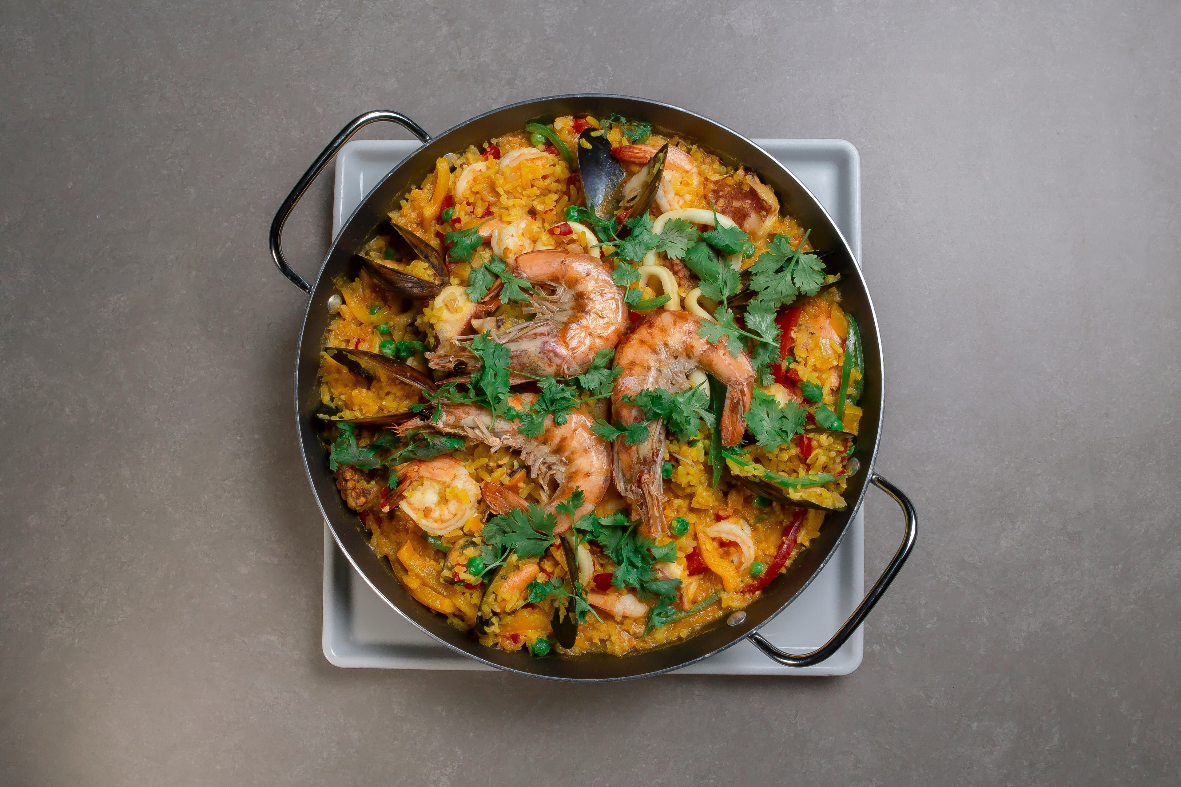 A round pan with paella with shrimp