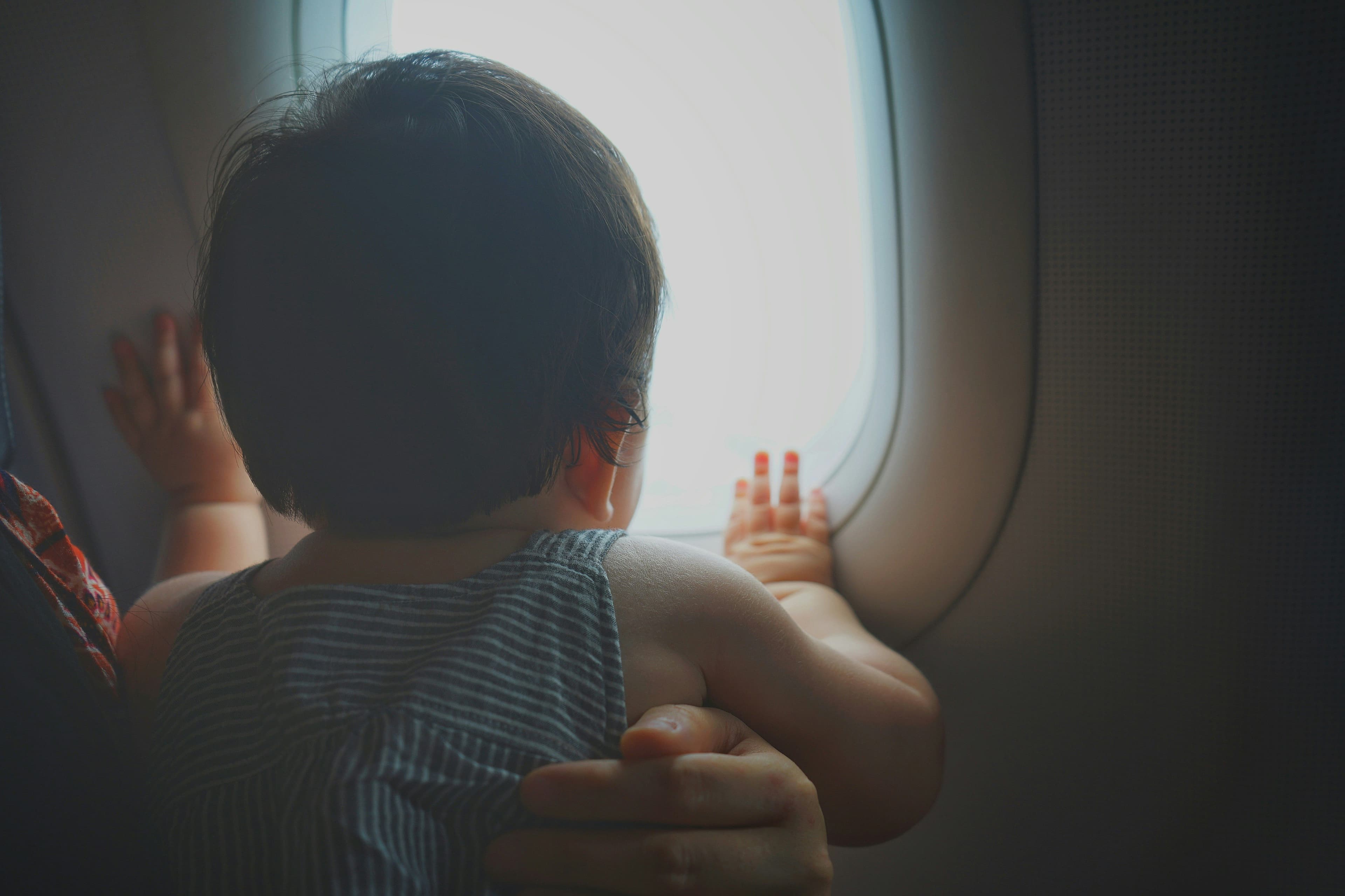 baby looking out plane window
