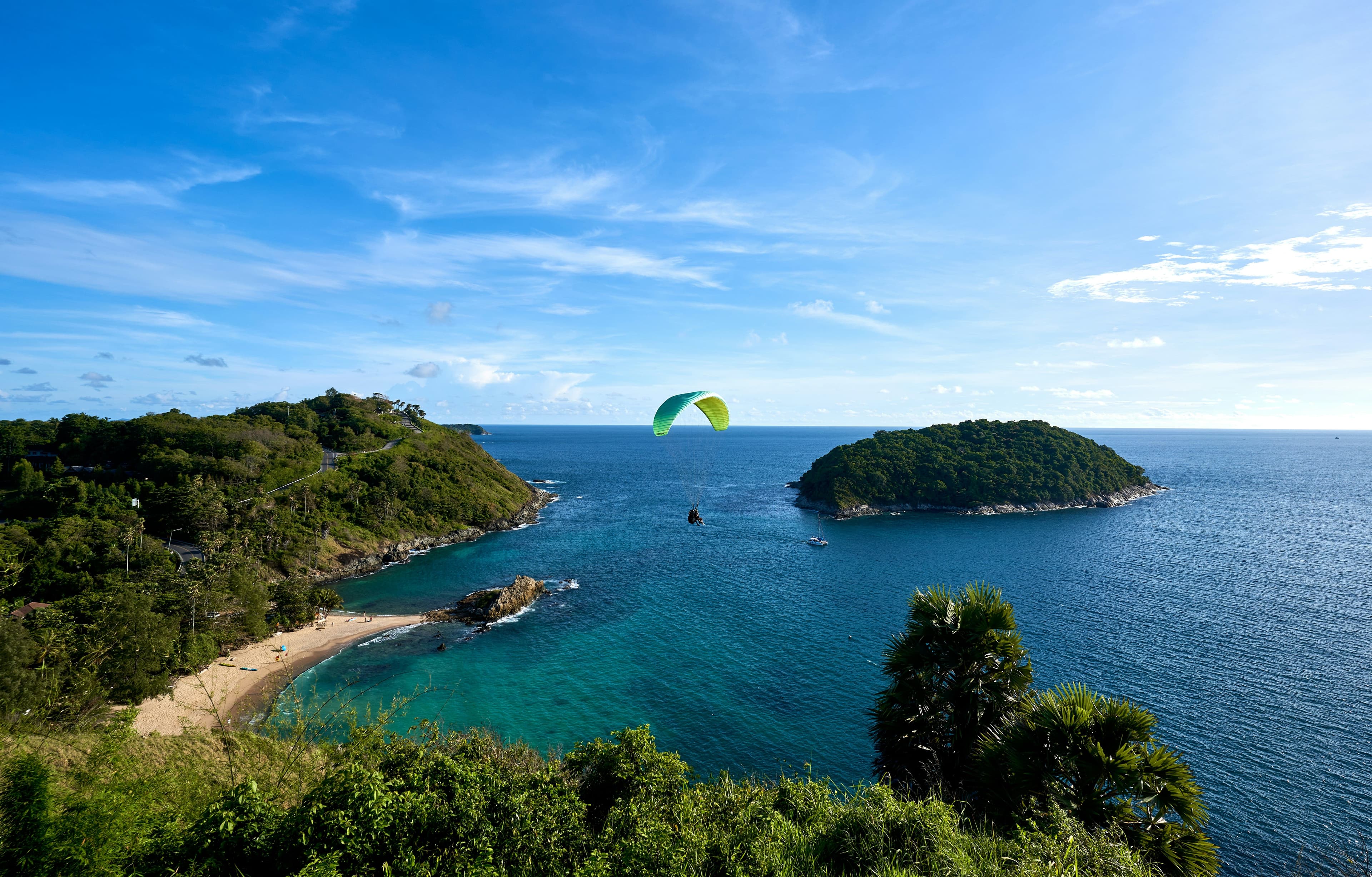 Bay of Islands, an aerial view of the ocean with islands and mountains and a paraglider